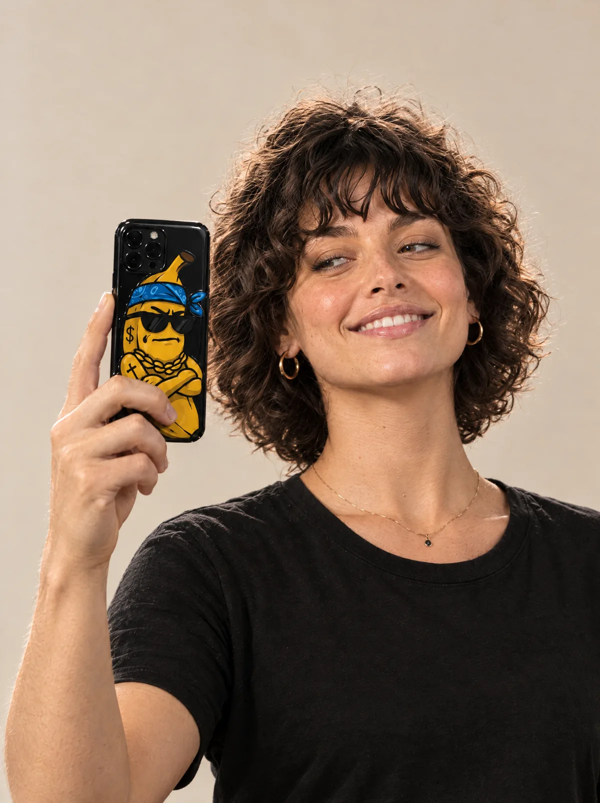 The young woman taking a selfie with a phone case printed with a cool banana in sunglasses